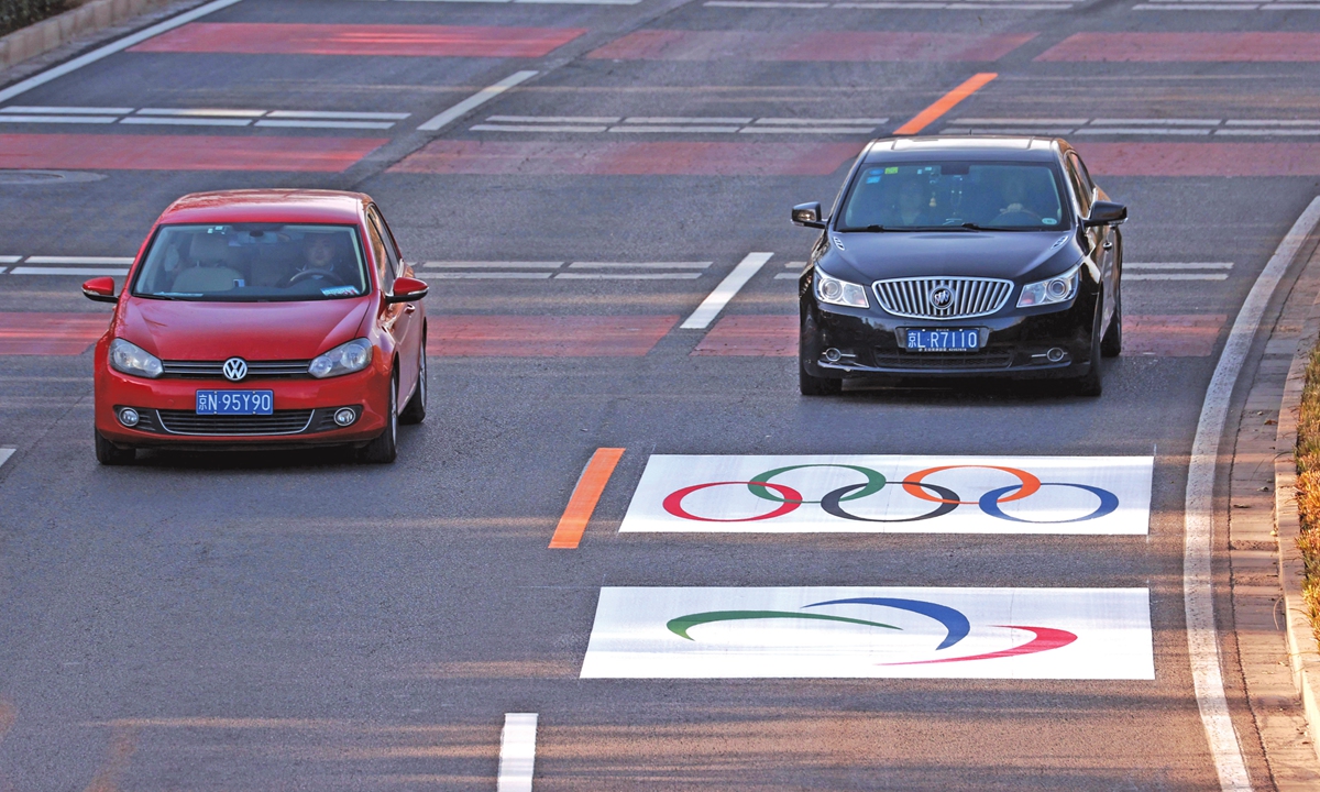 Olympic logos are seen painted on the main traffic lanes in the city center of Beijing on Saturday.Photo: VCG
